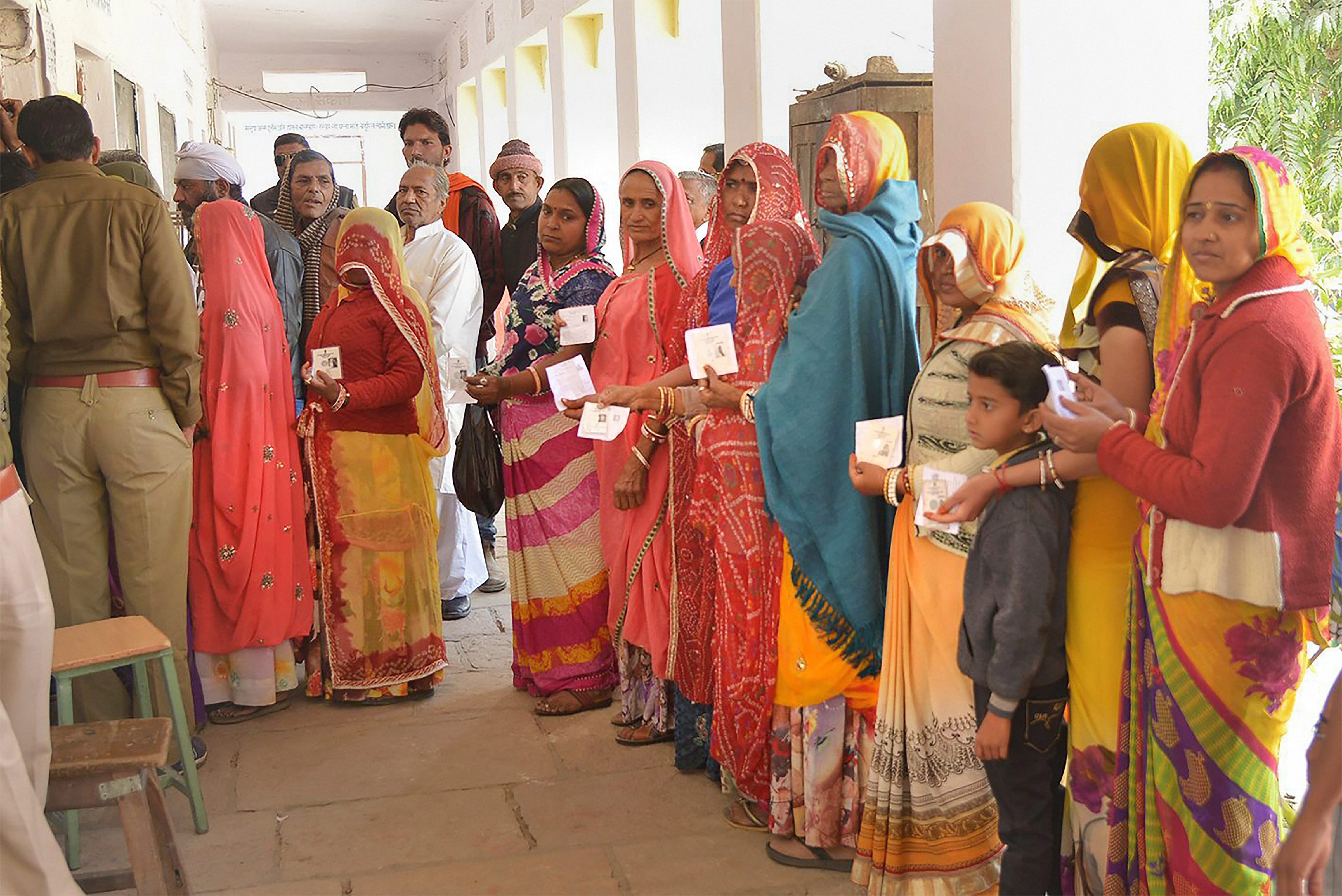 People wait to cast vote at a polling station in Ajmer, Rajasthan. (PTI File Photo)