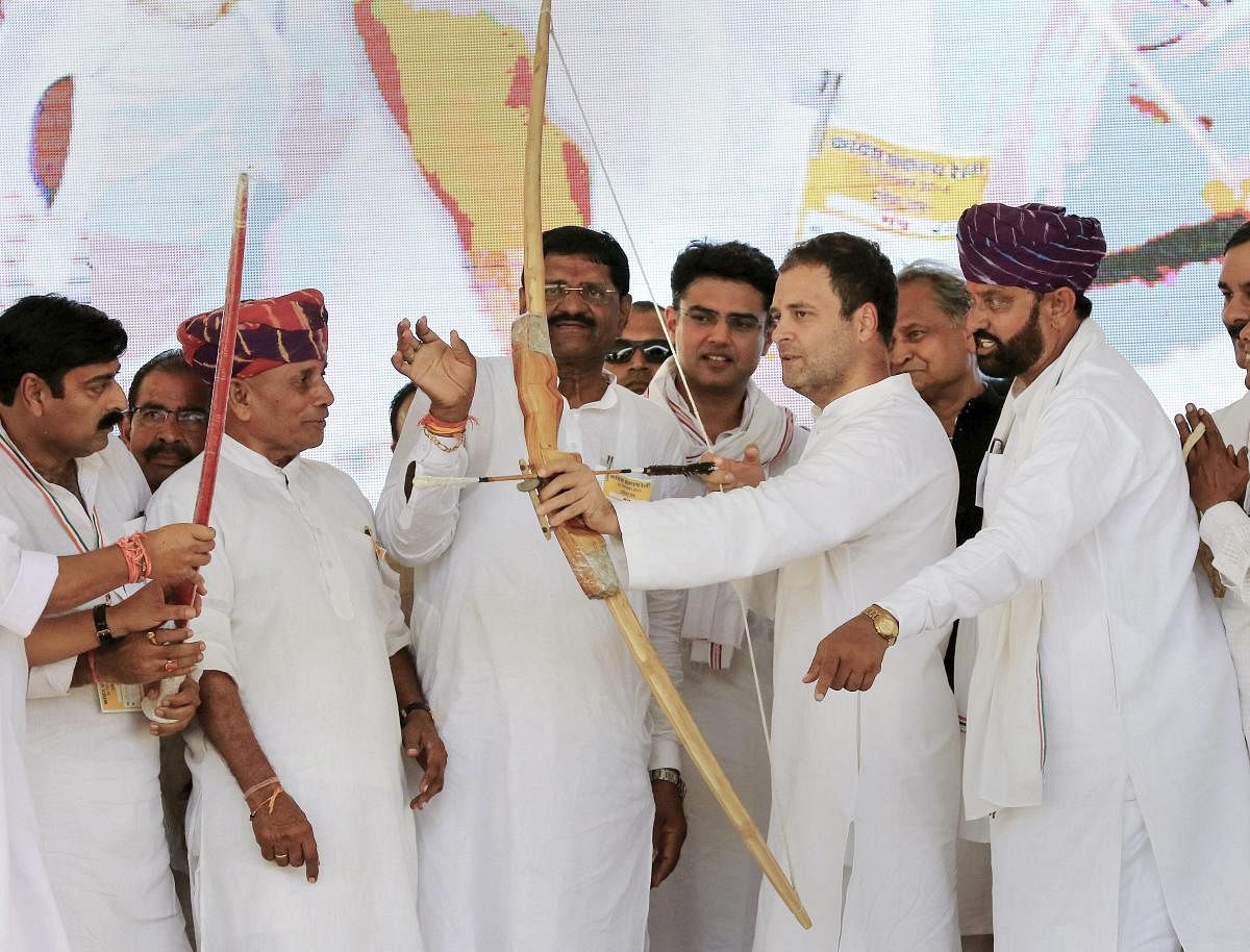 Congress president Rahul Gandhi being presented a 'bow and arrow' by the party workers during their 'Sankalp Rally' at Sangwara in Dungarpur, Rajasthan, on Thursday. PTI