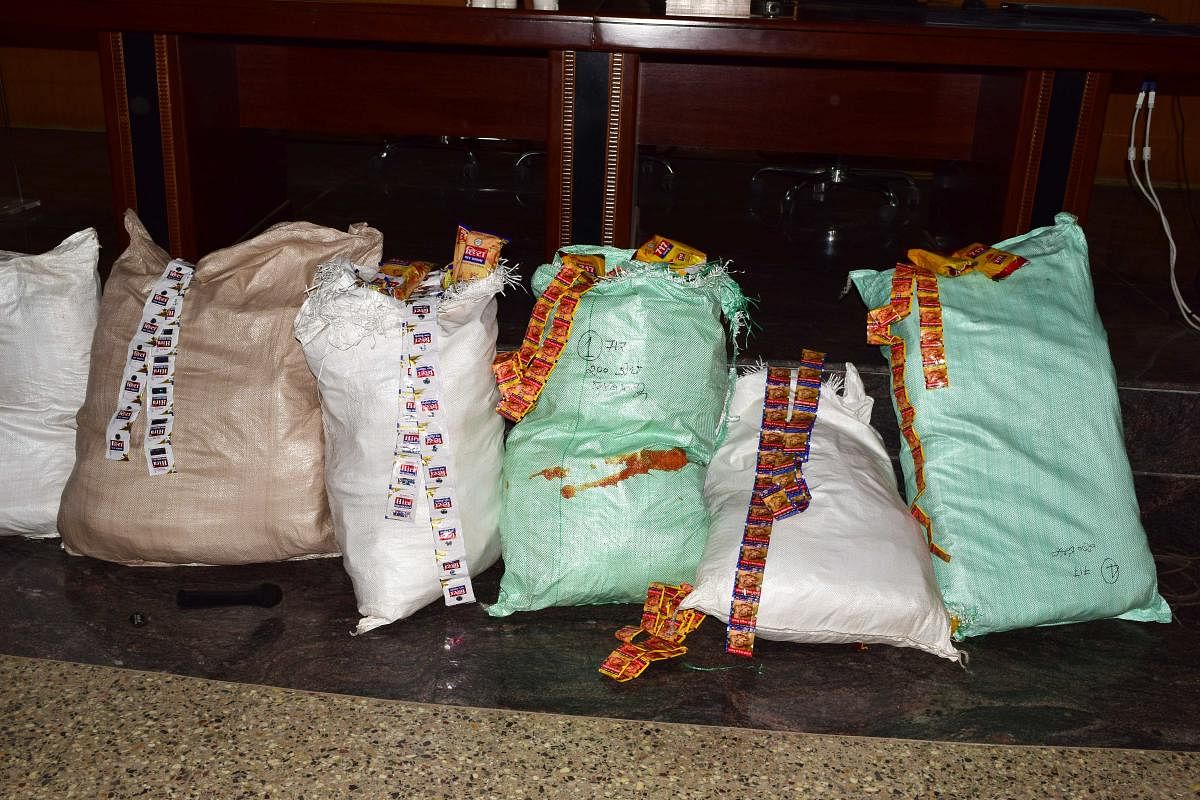 As many as 540 bags full of tobacco products valued at Rs 50 lakh being illegally stored in the form of sachets without valid documents were seized from a godown at Ginagera village in Koppal taluk on Wednesday. DH Photo
