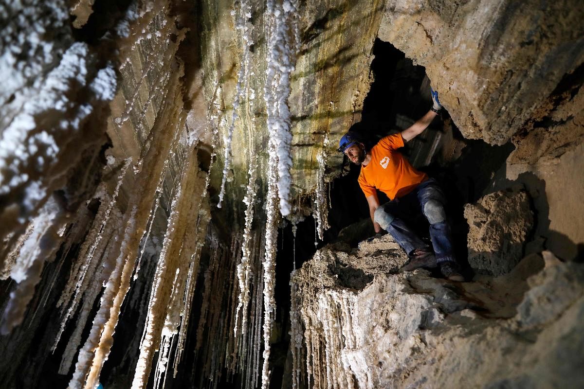 Efraim Cohen of the Israel Cave Explorers Club, and of the Malham Cave Mapping Expedition, shows journalists salt stalactites in the Malham cave inside Mount Sodom, located at the southern part of the Dead Sea in Israel. AFP