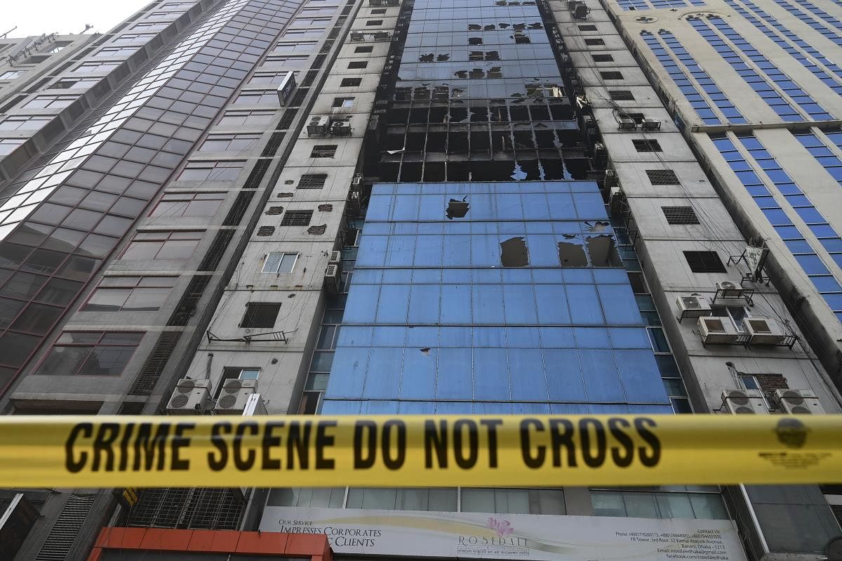 A crime scene ribbon surrounds the burnt building in Dhaka on March 29, 2019, a day after flames tore through the 22-storey FR Tower. (AFP Photo)