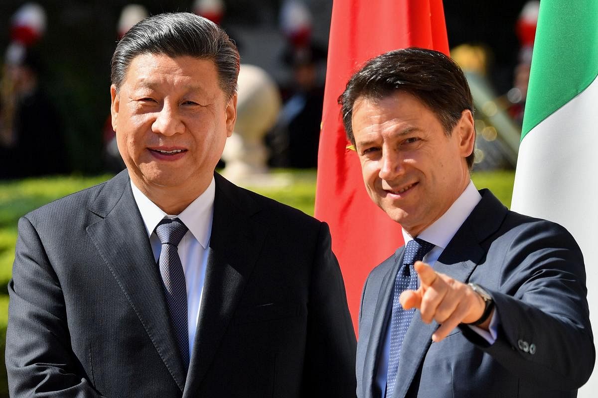 Italy’s Prime Minister Giuseppe Conte (R) greets China's President Xi Jinping during their meeting at Villa Madama in Rome on March 23, 2019. AFP