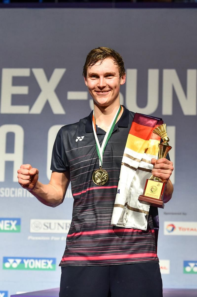 SENSATIONAL Denmark’s Viktor Axelsen with the trophy after defeating India’s K Srikanth in the final in New Delhi on Sunday. PTI