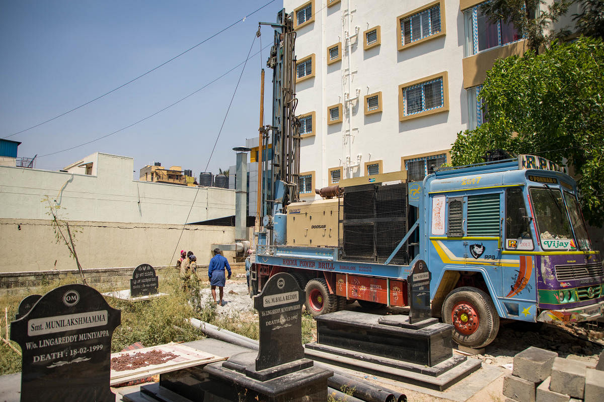 A borewell being dug inside a graveyard in HSR Layout in Bengaluru on Tuesday. DH Photo/Sudheesha K G