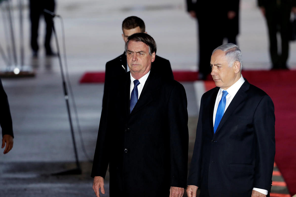 Brazilian President Jair Bolsonaro stands next to Israeli Prime Minister Benjamin Netanyahu during a welcoming ceremony upon his arrival in Israel, at Ben Gurion International airport in Lod, near Tel Aviv, Israel March 31, 2019. REUTERS