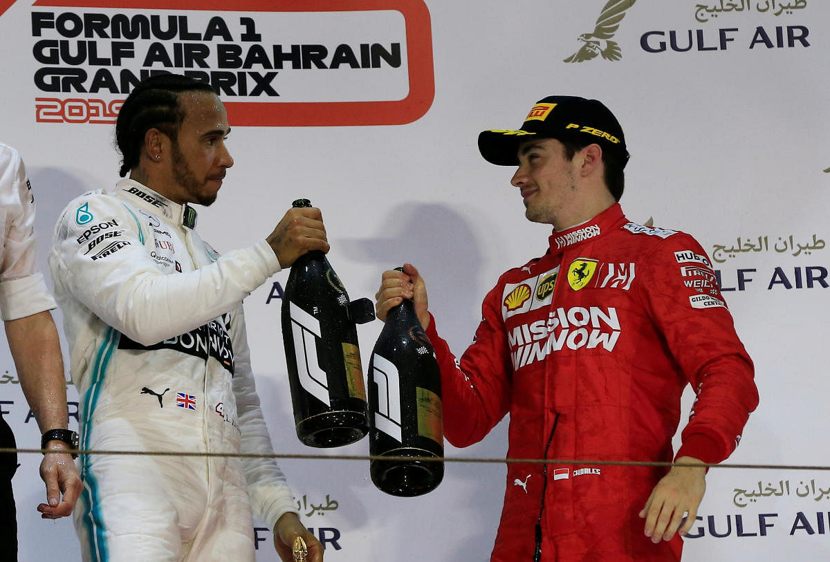CHEERS: Mercedes' Lewis Hamilton celebrates his victory with Ferrari's Charles Leclerc on the podium after the Bahrain Grand Prix on Sunday. Reuters
