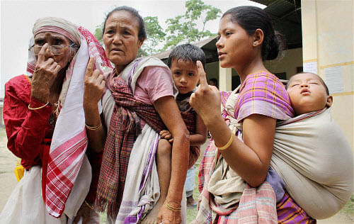 Mising tribal women show their ink-marked fingers after casting votes during the first phase of voting for Lok Sabha elections in Sivasagar on Monday. PTI Photo