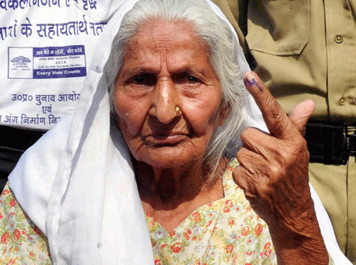 An elderly woman shows her inked finger after casting vote for 8th phase of Lok Sabha Election in Allahabad on Wednesday. PTI Photo