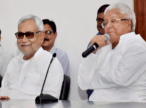 JD(U) leader & Bihar Chief Minister Nitish Kumar with RJD chief Lalu Prasad during a press conference in Patna on Wednesday. PTI Photo