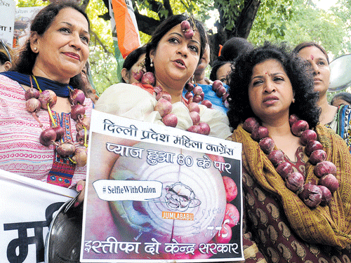 Activists of Mahila Congress shout slogans during their protest against Modi govt, on the issue of price rise of onion, at BJP Headquarters  in New Delhi on Monday.