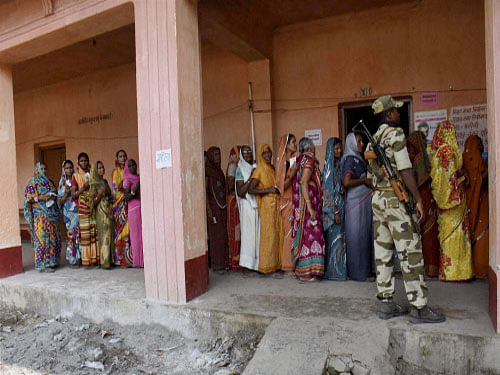 Voterswait in queues to cast their votes at a polling station inBegusarai onMonday during the first phase of Bihar Assembly elections. PTI