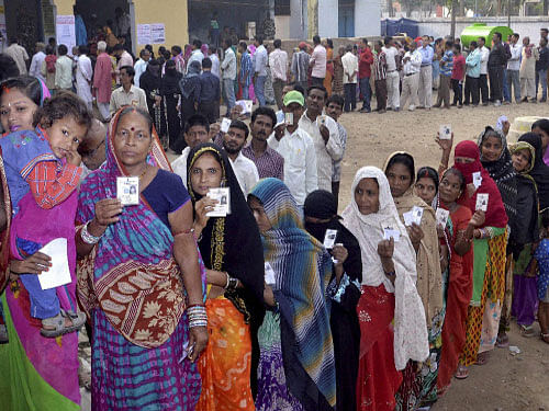 People stand in queue to cast their ballots at a voting centre in Darbhanga, Bihar, on Thursday. PTI photo