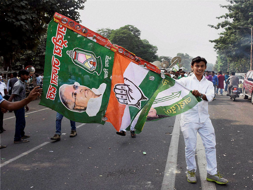 Grand alliance supporters celebrate after the victory in Bihar assembly elections in Patna on Sunday. PTI Photo