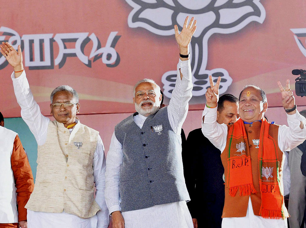 Prime Minister Narendra Modi (C) along with Manipur BJP president K. Bhabananda (L) and senior party leader Th. Chaoba (R) at an election rally at Langjing Achouba ground, Imphal West on Saturday. PTI Photo