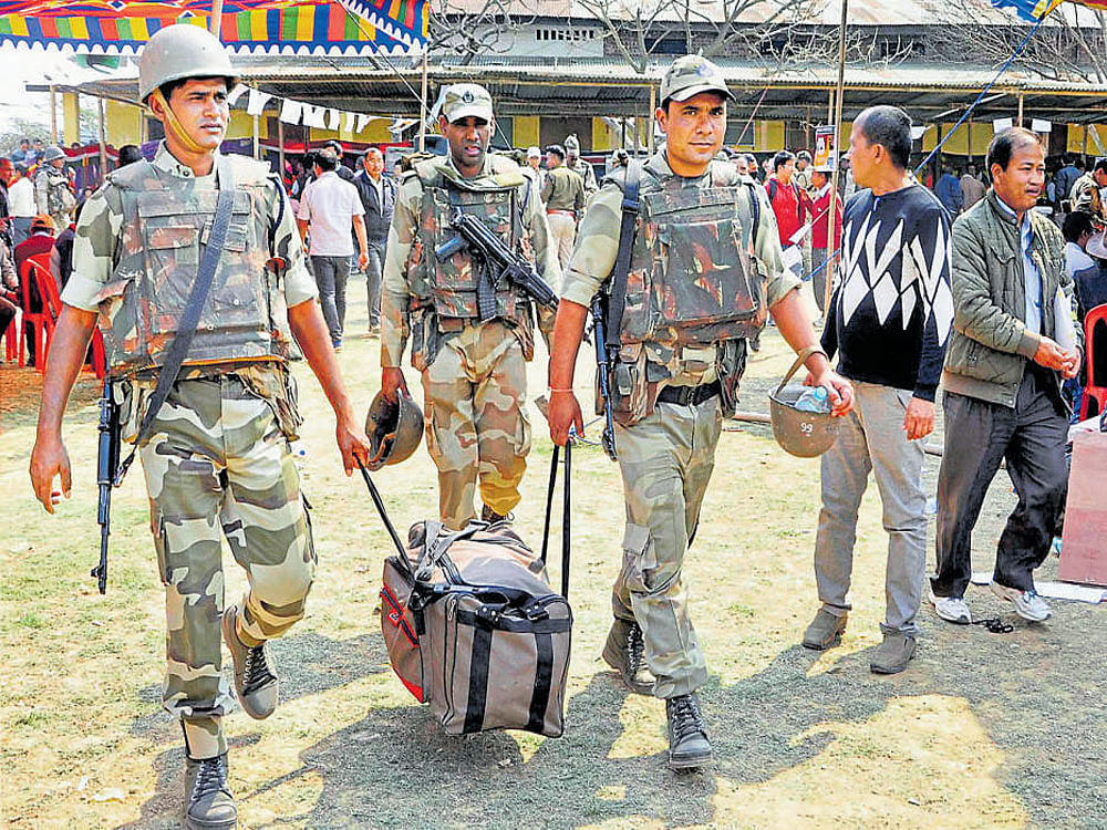A day ahead of polling, security personnel make arrangements at Porompat in Imphal East on Friday. PTI