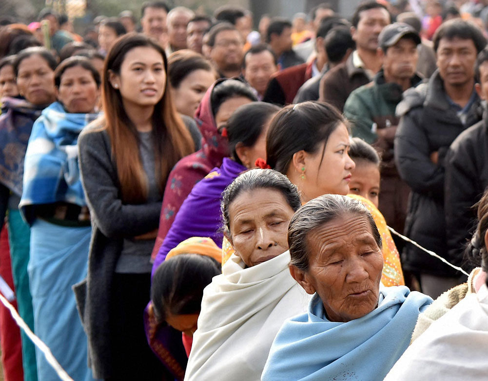 Manipuri people stand in a queue to cast their votes in Thoubal constituency of Manipur on Wednesday during the last phase of state assembly elections. PTI Photo