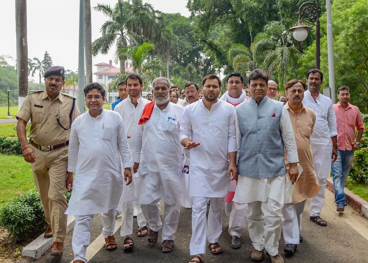 Opposition leader in Bihar Tejashwi Yadav with RJD and Congress MLAs after meeting with Bihar Governor Satyapal Malik to stake claim to form the government in the state, being the single largest party in the Legislative Assembly, in Patna on Friday. PTI