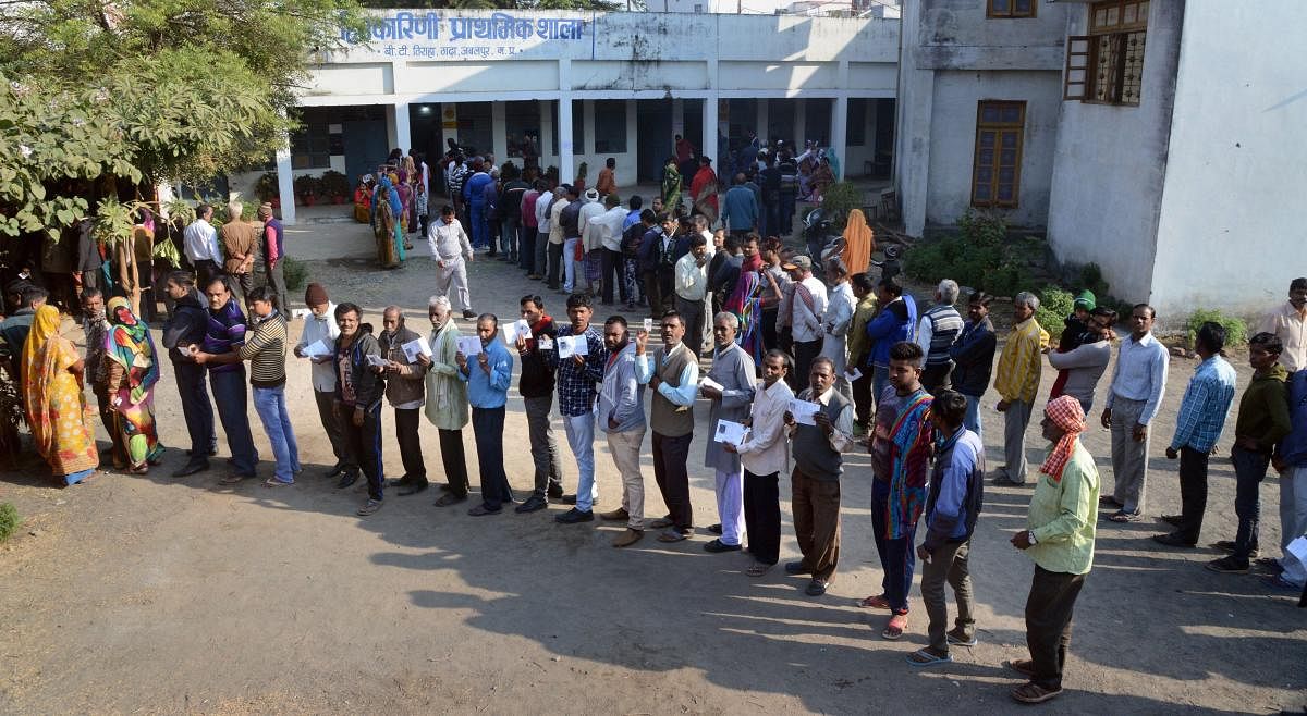 People wait with their identity cards to cast their votes for the Assembly elections, in Jabalpur, Madhya Pradesh, Wednesday, Nov 28, 2018. (PTI Photo)