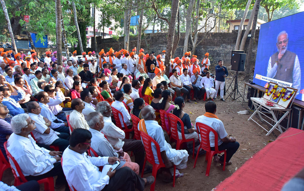 People at the inauguration of screening of 'Main Bhi Chowkidar' live address by Prime Minister Narendra Modi, at BJP district election office in Mangaluru on Sunday.