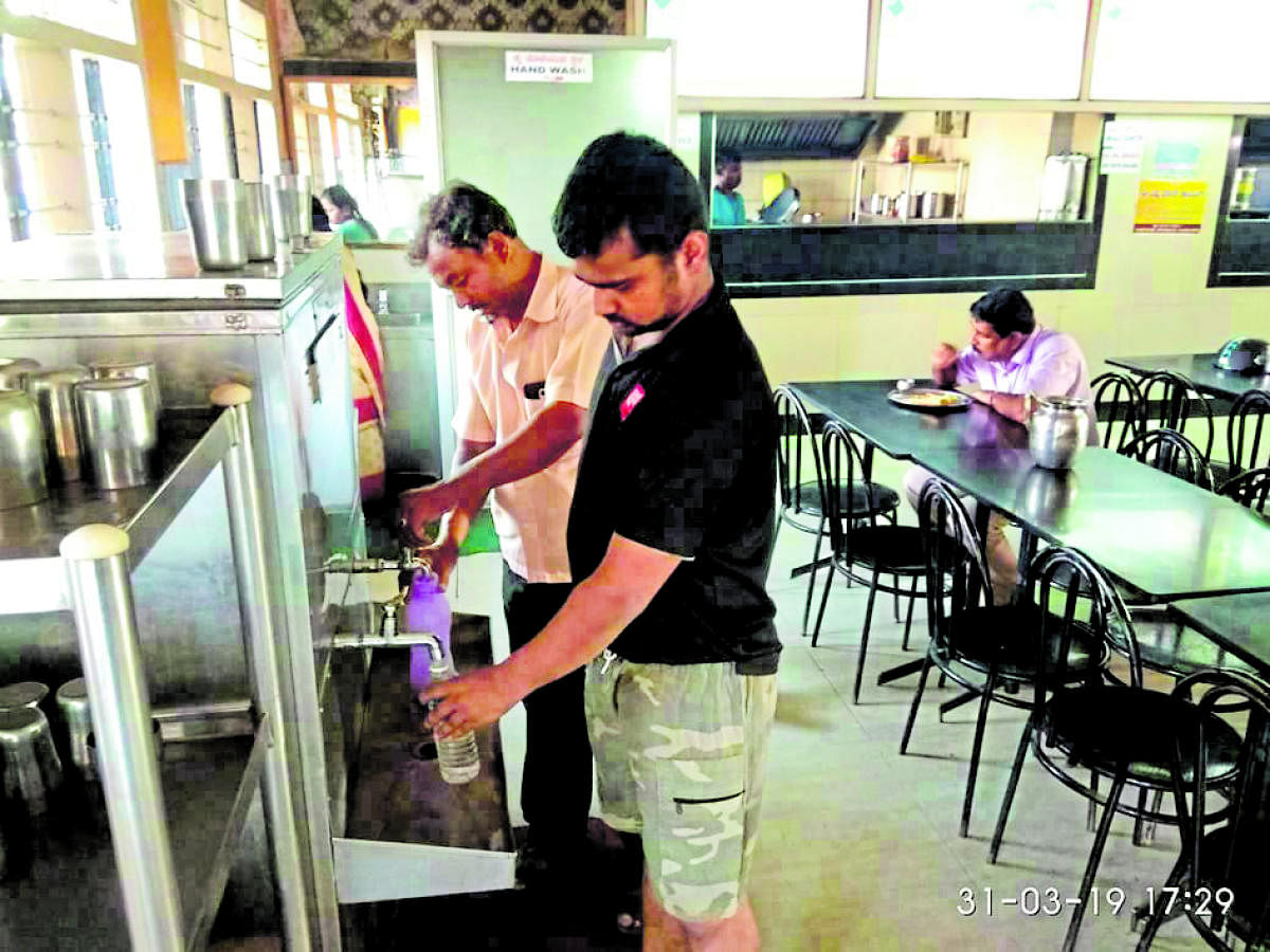 Passengers at KSRTC bus stand fill their water bottles from the taps available in hotels.