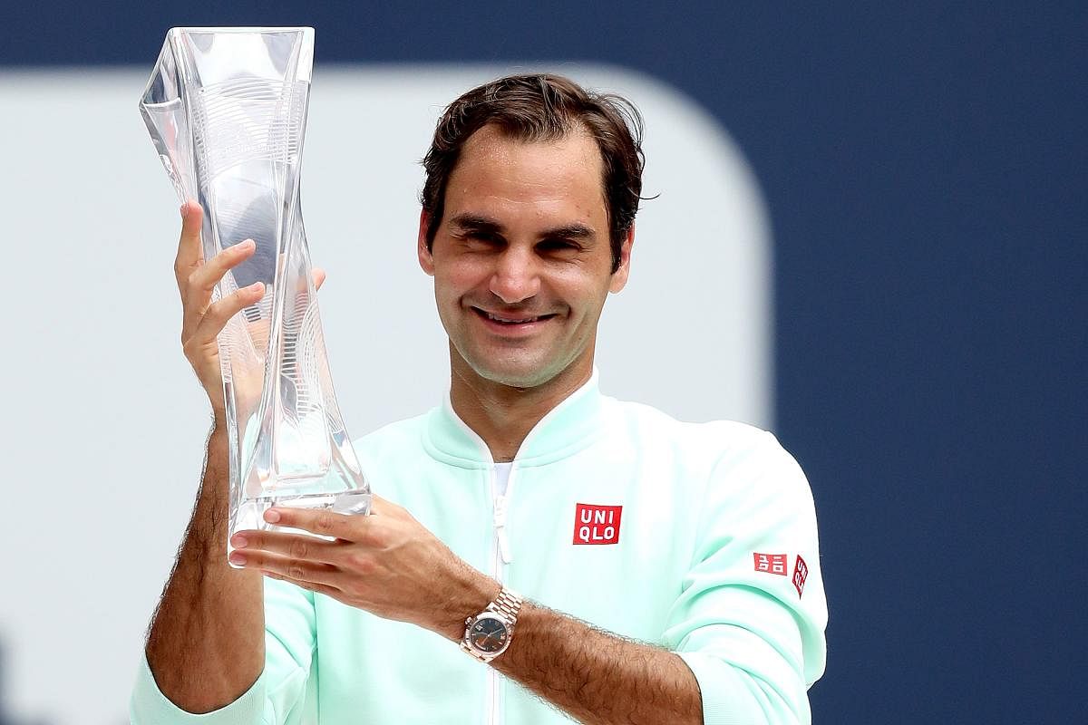 Roger Federer of Switzerland celebrates with the Butch Buchholz Trophy after defeating John Isner during the men's final of the Miami Open Presented by Itau at Hard Rock Stadium in Miami Gardens, Florida. AFP photo