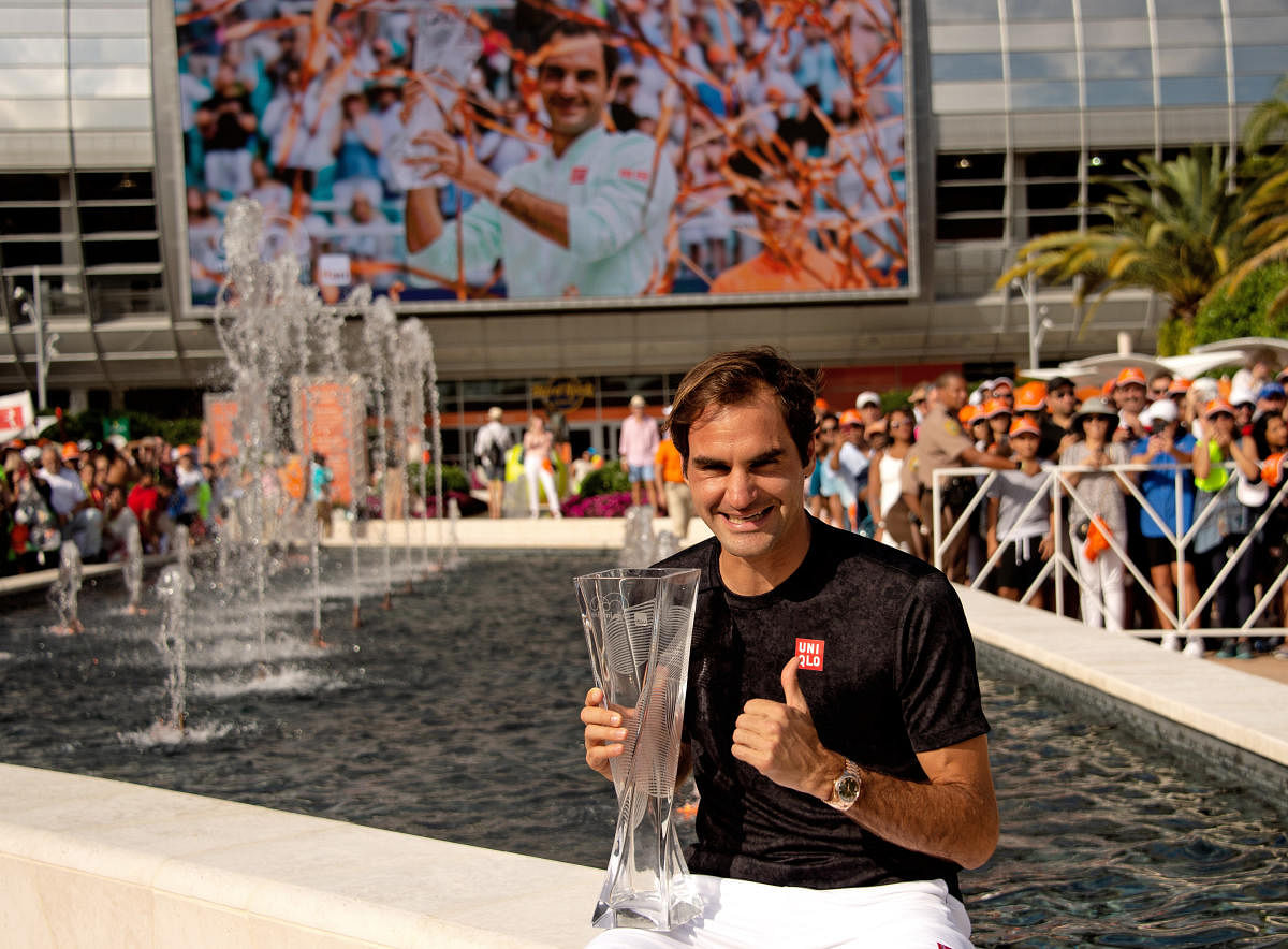 CLASSY: Roger Federer of Switzerland poses with the Miami Open trophy after defeating John Isner of the United States. USA Today 