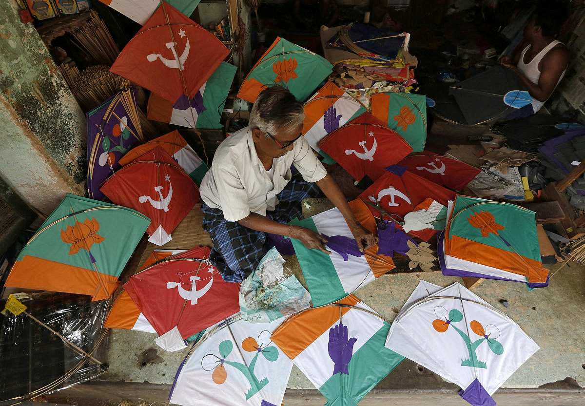 A kite-maker prepares kites with election symbols of political parties at his shop ahead of the general election, in Kolkata. REUTERS