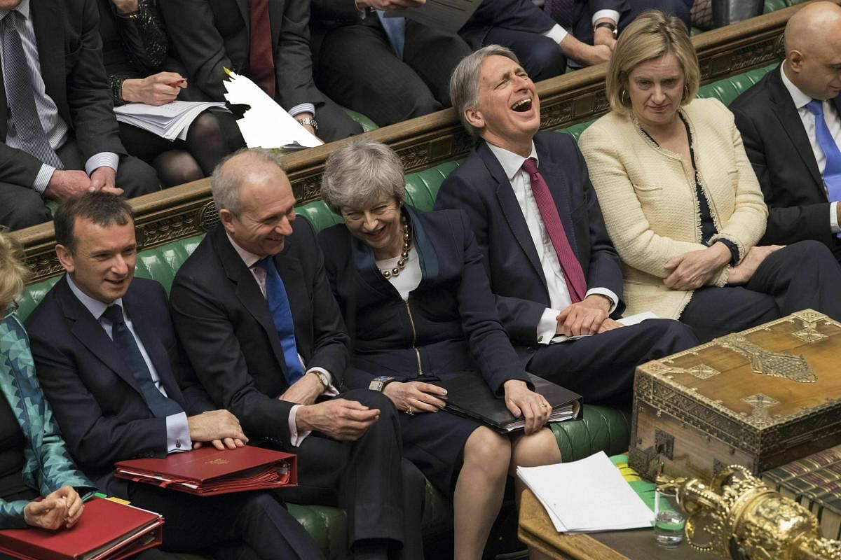 In this photo provided by the UK Parliament, Britain's Prime Minister Theresa May, center, laughs during Prime Minister's question in the Palace of Westminster in London. (AP/PTI Photo)