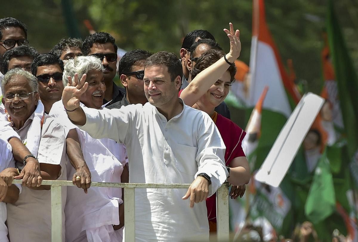 Congress President Rahul Gandhi along with party General Secretary and Uttar Pradesh - East in charge Priyanka Gandhi Vadra and other leaders wave at party supporters during a roadshow ahead of the former's nomination filing, ahead of the Lok Sabha electi