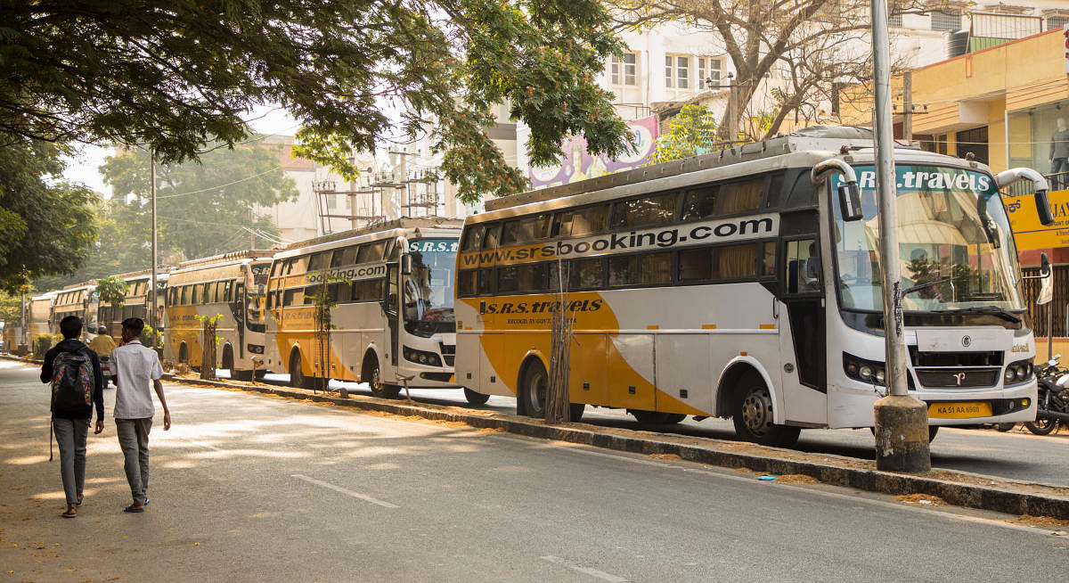 Buses belonging to SRS Travels are parked wrongly on the main road for three to four hours, narrowing the space available for other vehicles to get by. DH Photos by Sudheesha K G and prarthan d r