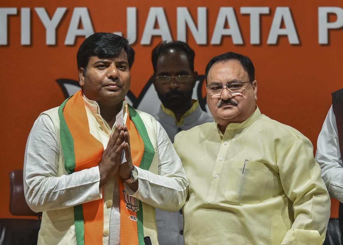 BJP leader and Union minister J P Nadda greets Nishad Party leader and Gorakhpur MP Praveen Nishad after he joined the BJP, in New Delhi on April 04. PTI