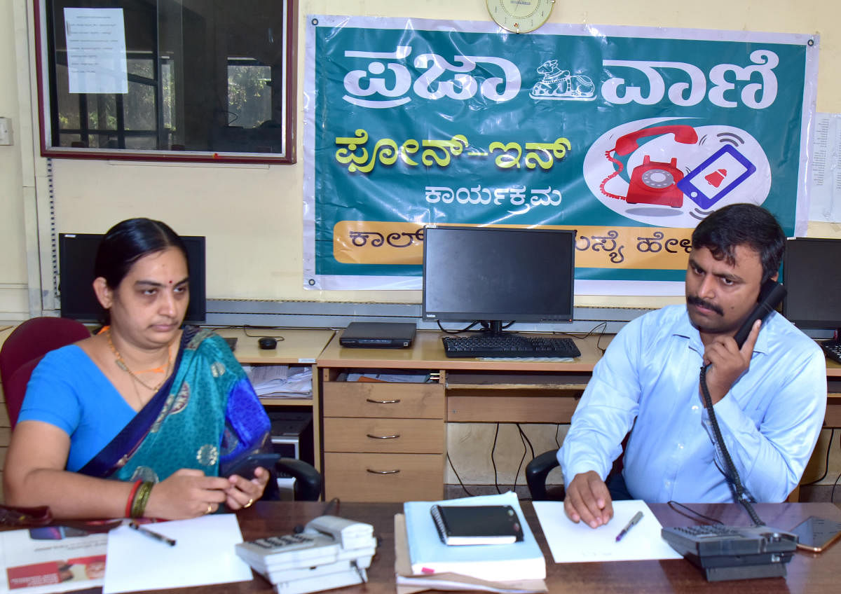 Sveep Committee Chairman and Zilla Panchayat Chief Executive Officer R Selvamani attends a phone call during phone-in programme organised by Prajavani at DH-PV Editorial Office in Balmatta on Friday. Assistant Returning Officer Gayathri Nayak looks on.