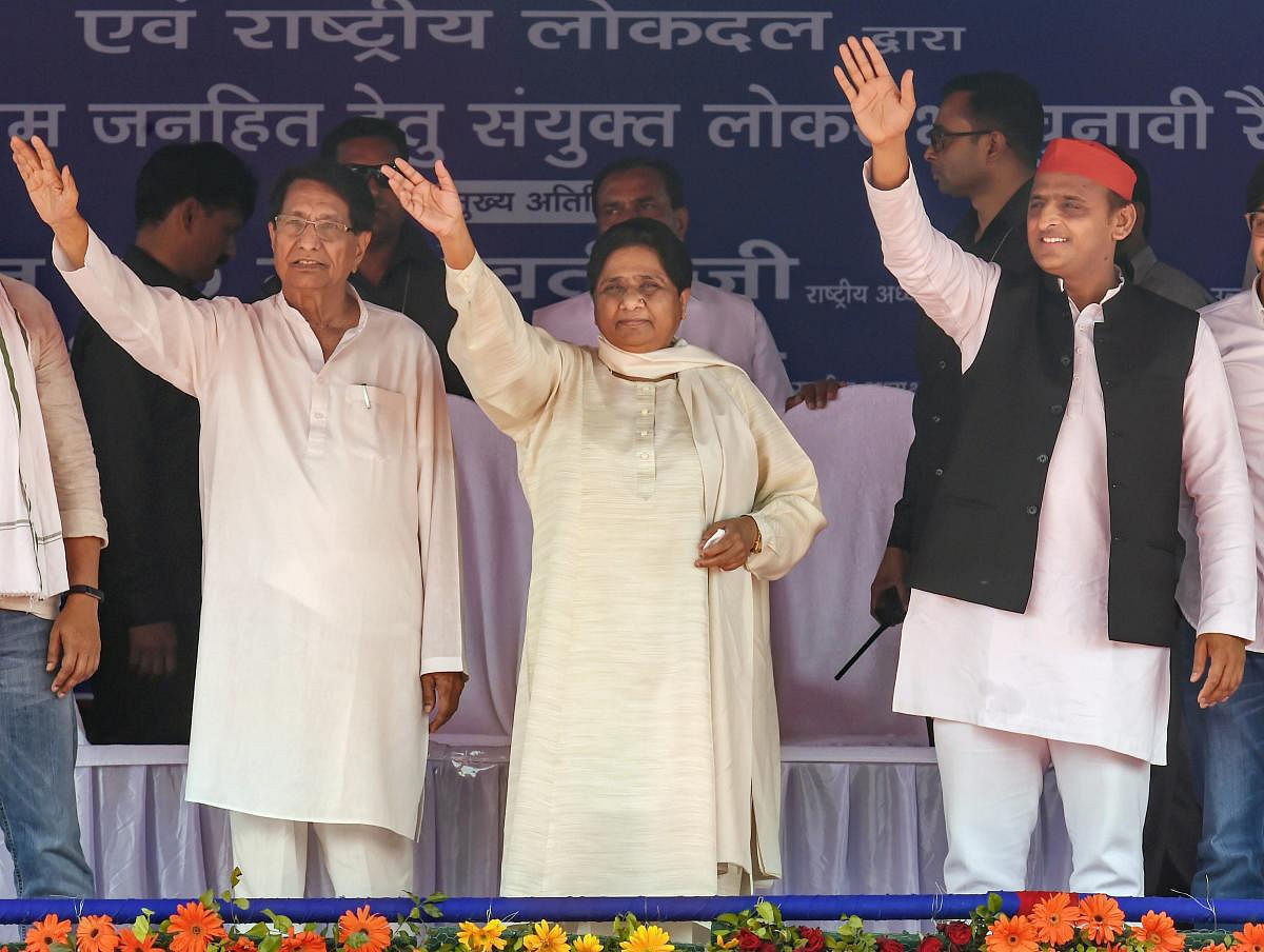 Samajwadi Party President Akhilesh Yadav, Bahujan Samaj Party supremo Mayawati, RLD chief Ch Ajit Singh wave at the supporters during their joint election campaign rally at Deoband in Saharanpur, Sunday, April 7, 2019. (PTI Photo) 