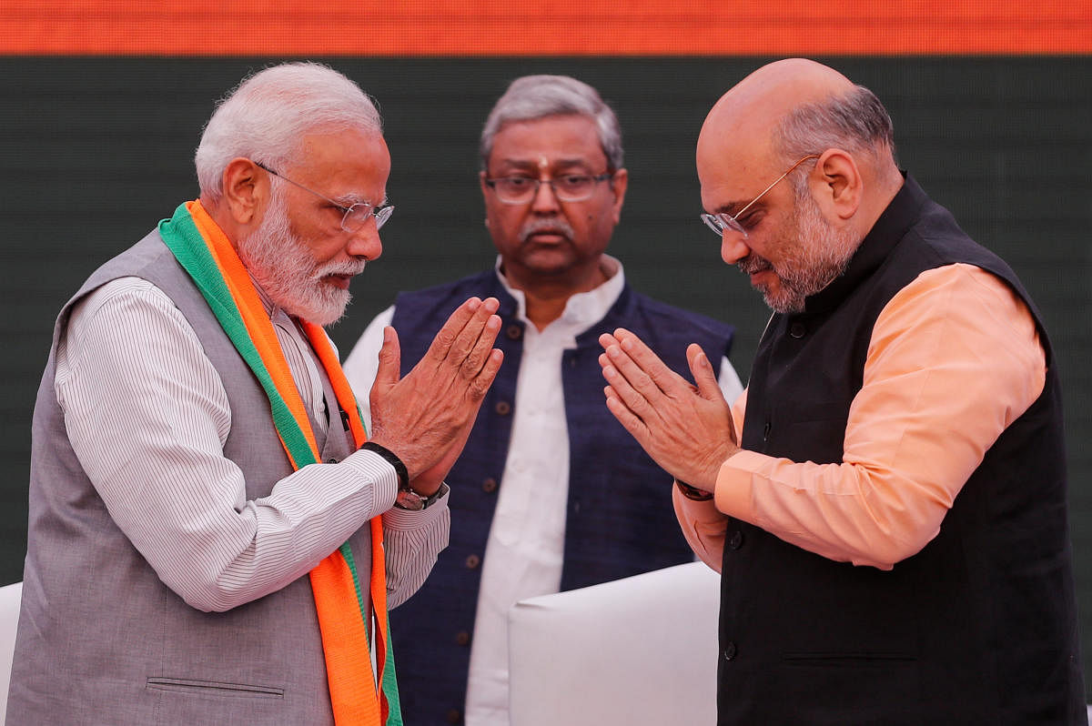 Prime Minister Narendra Modi and chief of India's ruling Bharatiya Janata Party (BJP) Amit Shah, greet each other before releasing their party's election manifesto for the April/May general election. Reuters