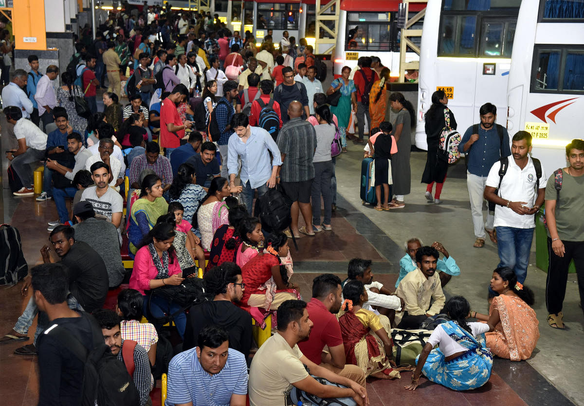 People headed for hometowns wait for buses at the KSRTC bus stand in Bengaluru on Friday. DH Photo/S K Dinesh