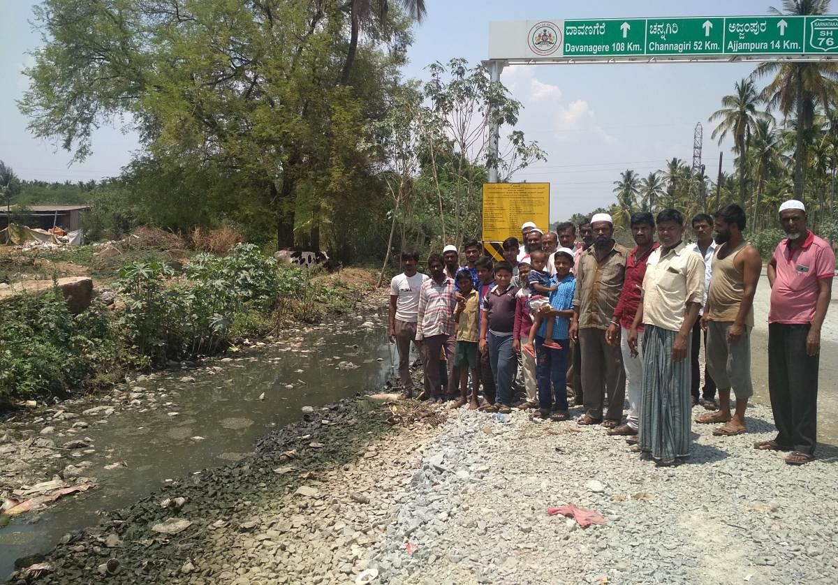 Residents stage a protest on Ajjampura Road, highlighting the pathetic condition of the stormwater drain.