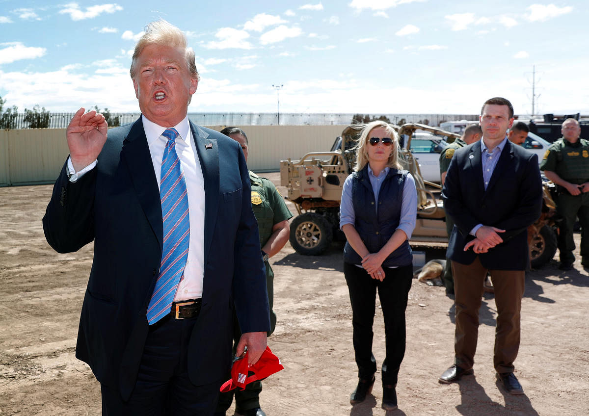 Homeland Security Secretary Kirstjen Nielsen and commissioner for Customs and Border Patrol Kevin McAleenan listen to U.S. President Donald Trump speak during a visit to a section of border wall in Calexico California, U.S. Reuters photo