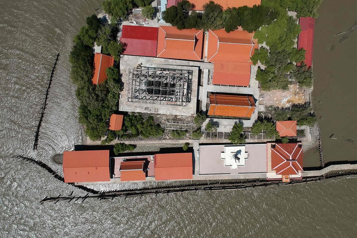 This aerial photo taken on March 9, 2019 shows a view of a Buddhist temple isolated by coastal erosion in Samut Chin village, off the shore of Samut Prakan. (AFP Photo)