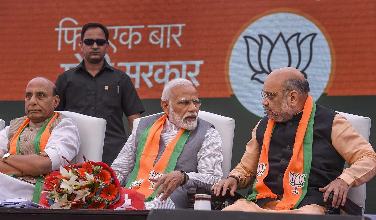 Prime Minister Narendra Modi, BJP President Amit Shah and Union Home Minister Rajnath Singh during the release of Bharatiya Janata Party's (BJP) manifesto for Lok Sabha elections 2019, in New Delhi. (PTI Photo)