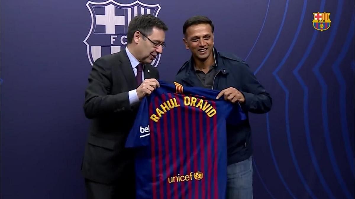 DELIGHTED Cricket legend Rahul Dravid (right) was presented with a personalised jersey at the Camp Nou.