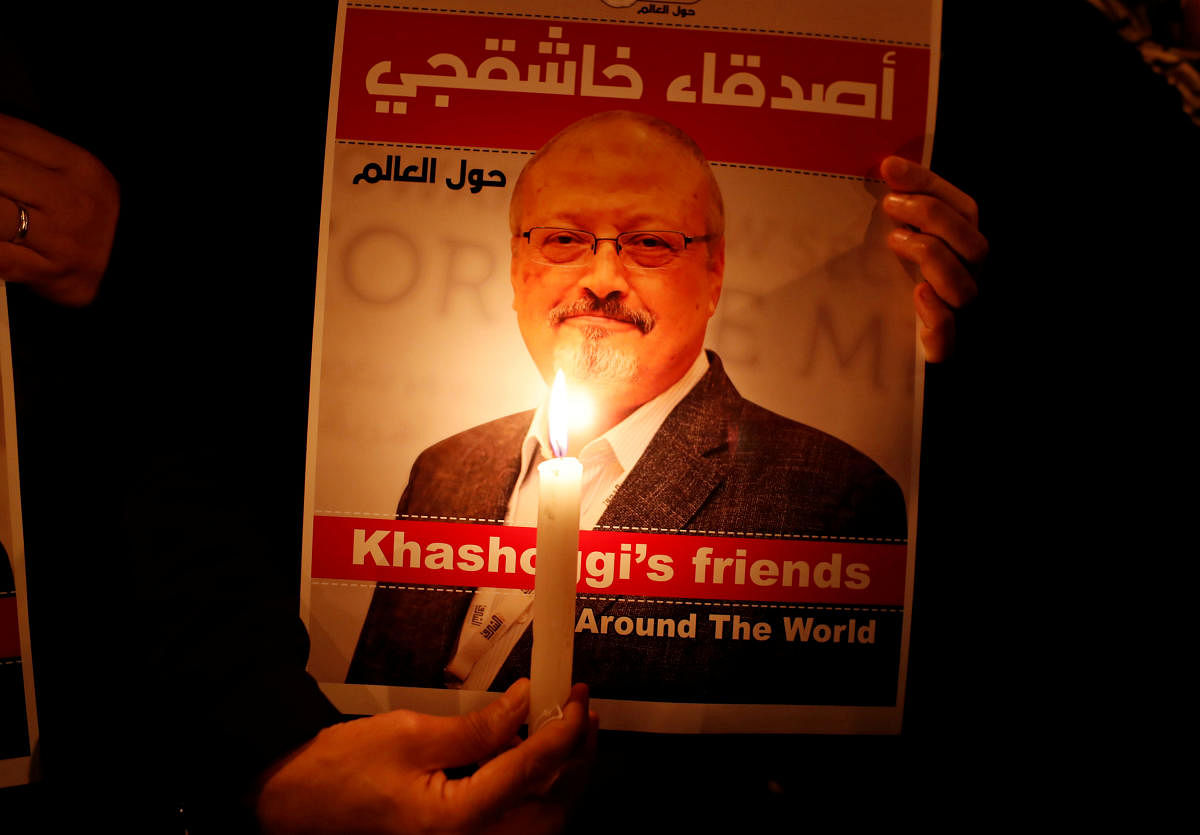 A demonstrator holds a poster with a picture of Saudi journalist Jamal Khashoggi outside the Saudi Arabia consulate in Istanbul, Turkey October 25, 2018. REUTERS