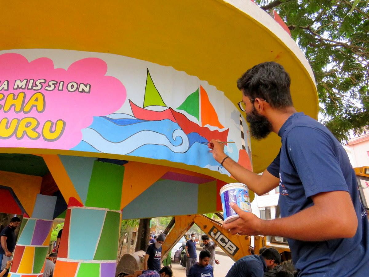 An artist paints a bus stand at Kadri Mallikatta as part of the Shramadaan of the Ramakrishna Mission Swacchata Abhiyan in Mangaluru.