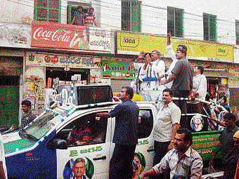 Sweating it out: Koneru Prasad of YSRC (folded hands) and YSRC Assembly candidate Jaleel Pasha campaigns in Vijayawada town on Sunday. PTI photo