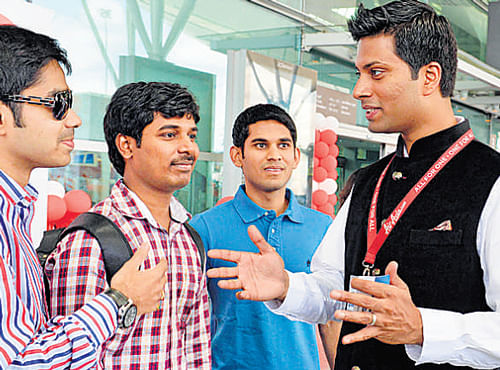 AirAsia India CEO Mittu Chandilya interacts with first-time passengers at the KIA on Thursday. DH photo