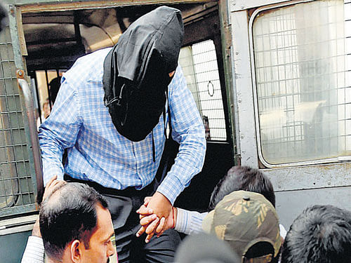 NIA officials produce ZIa-ul-Haque, arrested in connection with Burdwan blast at a local court in Kolkata on Saturday. PTI