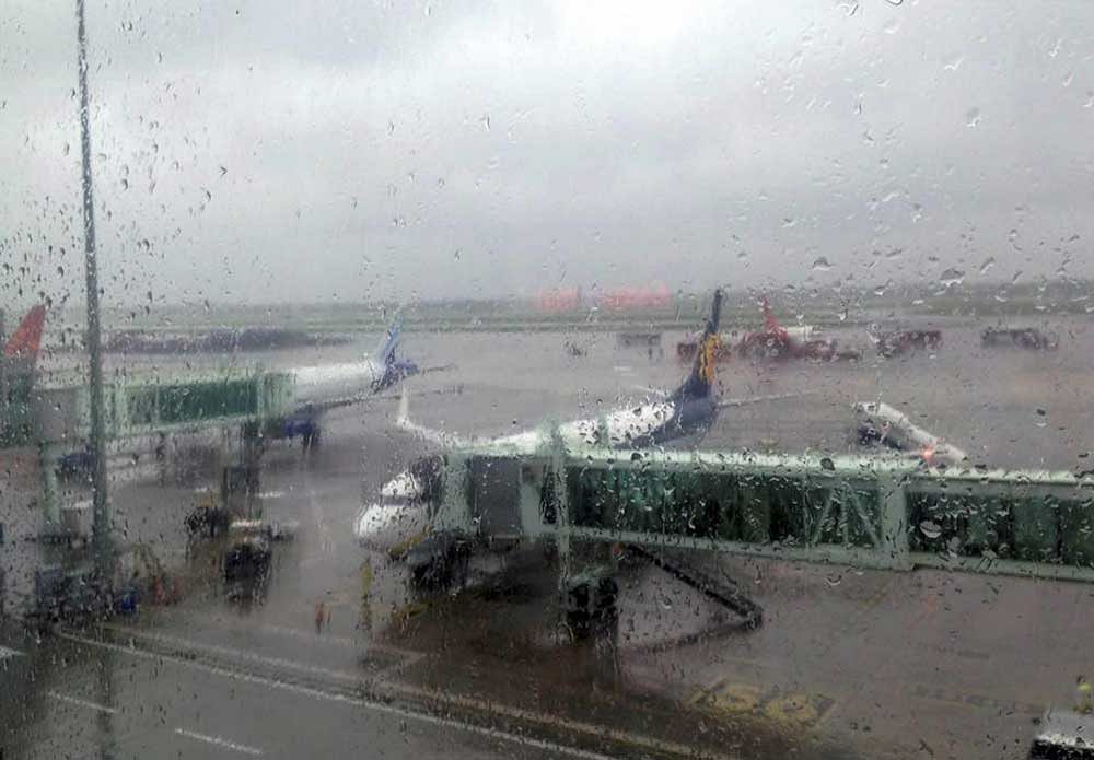 Aircraft are seen on the tarmac of the Netaji Subhas Chandra Bose International Airport during heavy rain in Kolkata on Monday. PTI