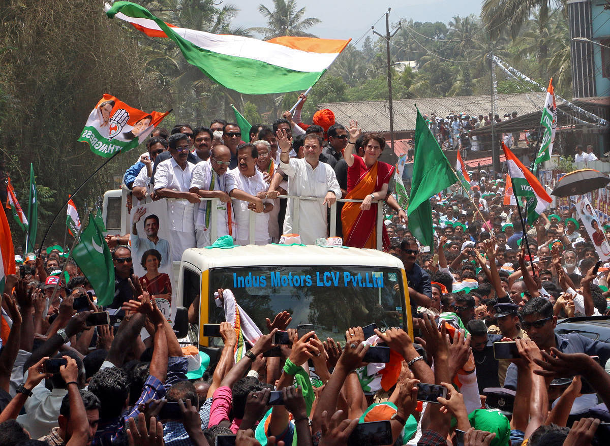 Congress chief Rahul Gandhi and his sister Priyanka Gandhi Vadra wave to their supporters after Rahul filed his nomination papers for the general election, in Wayanad in Kerala on April 4, 2019. REUTERS