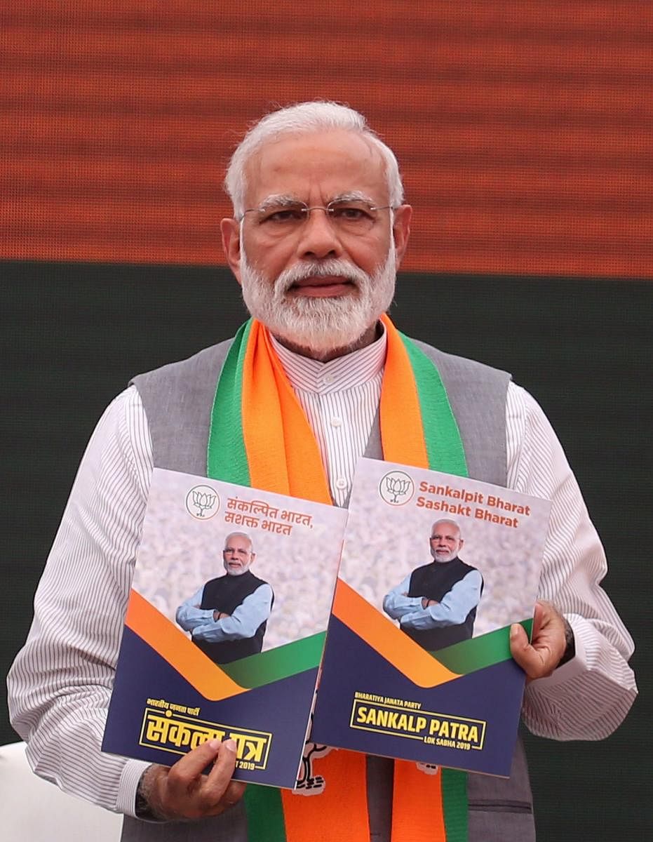 Prime Minister Narendra Modi presents the BJP election manifesto in New Delhi on April 8, 2019. STR/AFP