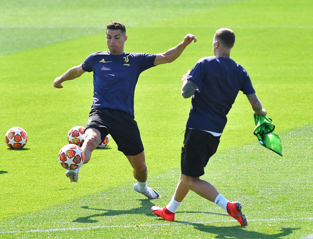Juventus’ Cristiano Ronaldo (left) trains on Tuesday ahead of their clash against Ajax. REUTERS