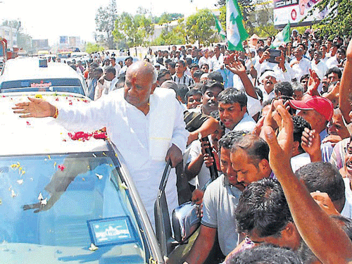 JD(S) partymen shower flowers on ex-prime minister H D Deve Gowda after he filed his nomination papers for Hassan Lok Sabha constituency, in Hassan, on Tuesday. DH Photo